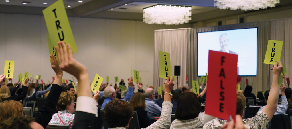 Group photo of people holding true or false signs