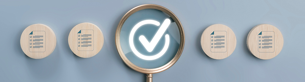 A magnifying glass hovers over a glowing white checkmark. There are four wooden tokens, two on each side of the magnifying glass. Each token has a checklist printed on it.