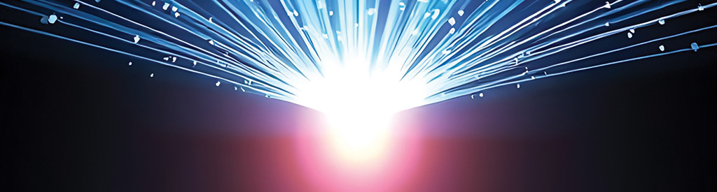 Rays of blue light radiate from a projector, illuminating specks of dust in a darkened room.