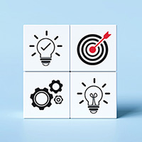 Four white tiles are arranged into a square against a light blue background. The top left tile has a light bulb icon with a checkmark in the center. The top right tile has a dartboard with a red arrow in the bullseye. The bottom left tile has three gear icons. The bottom right tile has a light bulb icon.