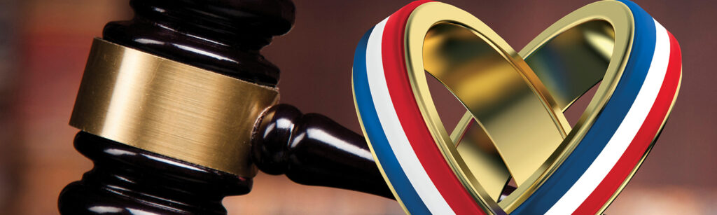 gavel next to intertwined gold rings, with the outer bands having a stripe each of red, white, and blue