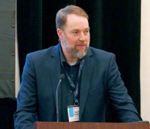 Photo of Darin Scheer speaking at CBAA