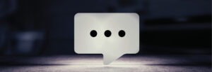 Image of square speech bubble with ellipsis on dark background