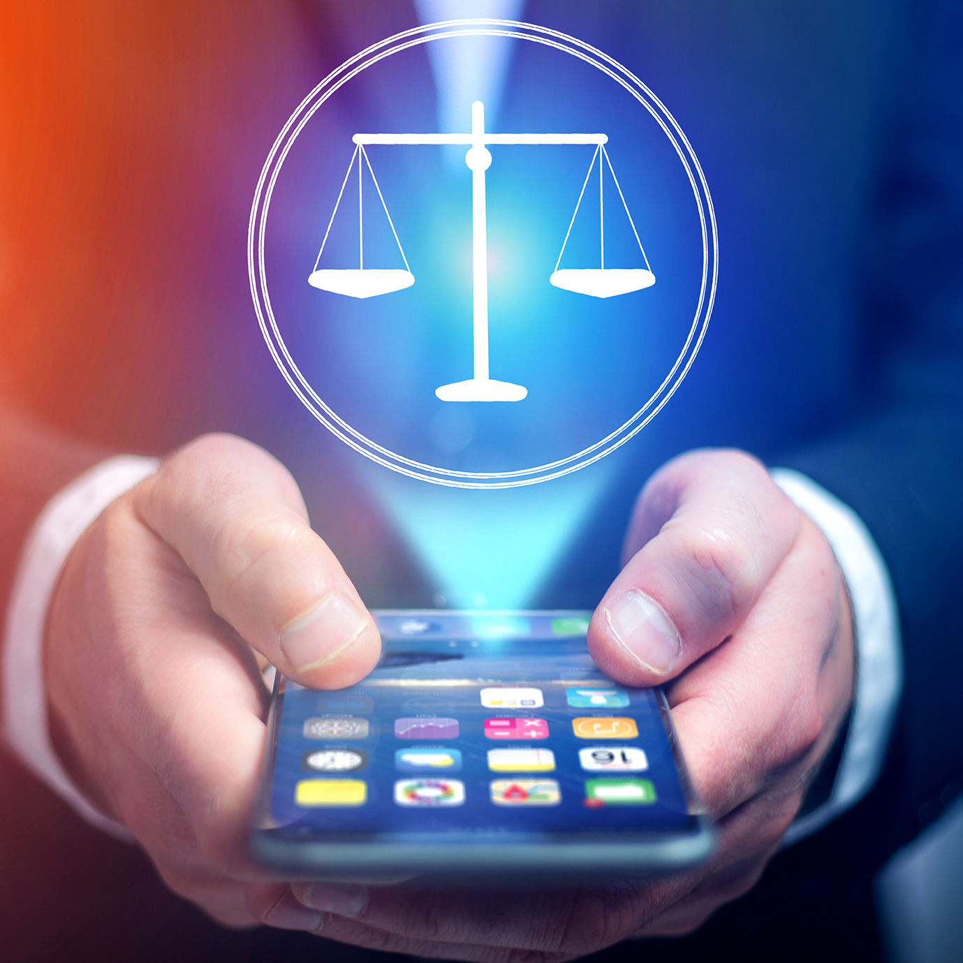 close up of a person in a suit holding a cellphone, with the screen active and visible. Beaming up from the screen is an image of white scales of justice