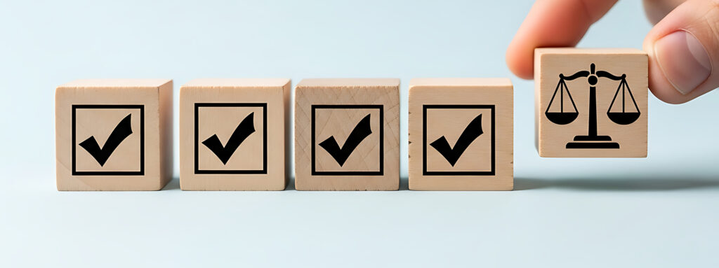 a row of wooden blocks with icons of checkmarks and the last block has an icon of a legal scale